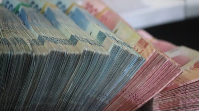Nilai Tukar Rupiah Melemah ke Rp14.410 per Dolar AS, Apa Penyebabnya?